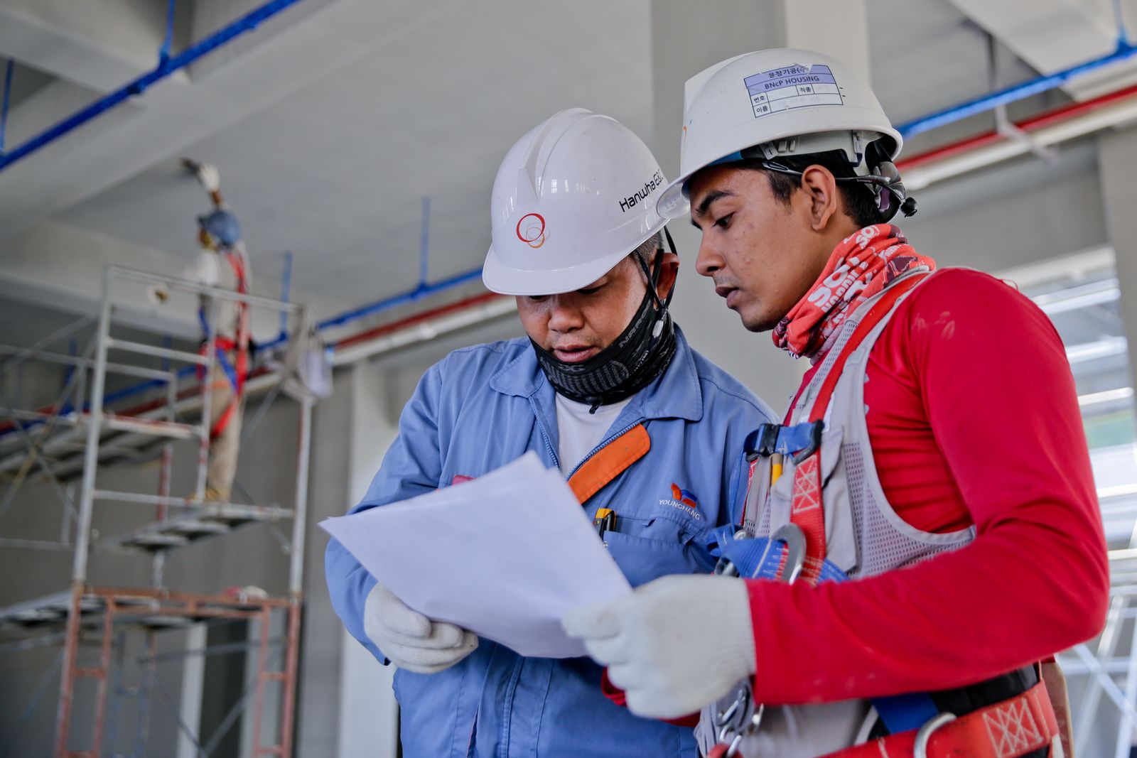 Construction colleagues reviewing work together